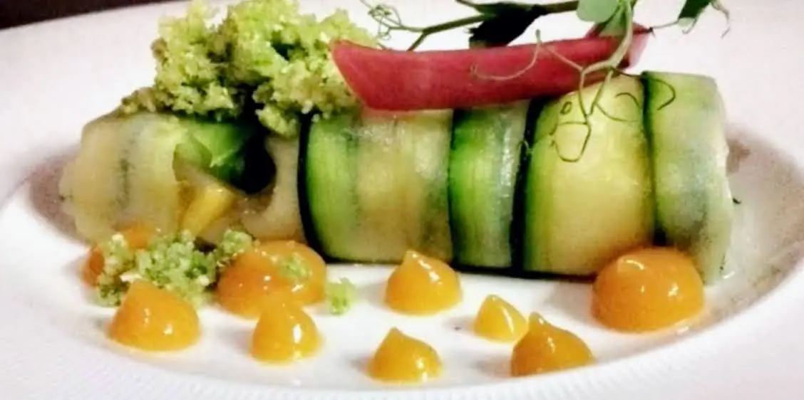 Roulé de concombre, perles de sauce orangée et herbes